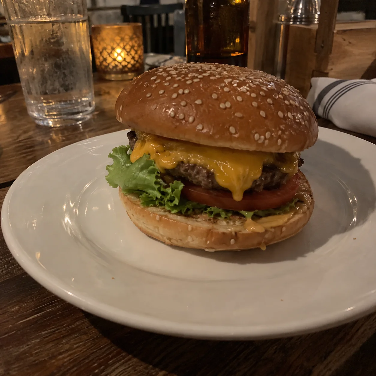 Original illustrative cheeseburger sample in dim warm table lighting